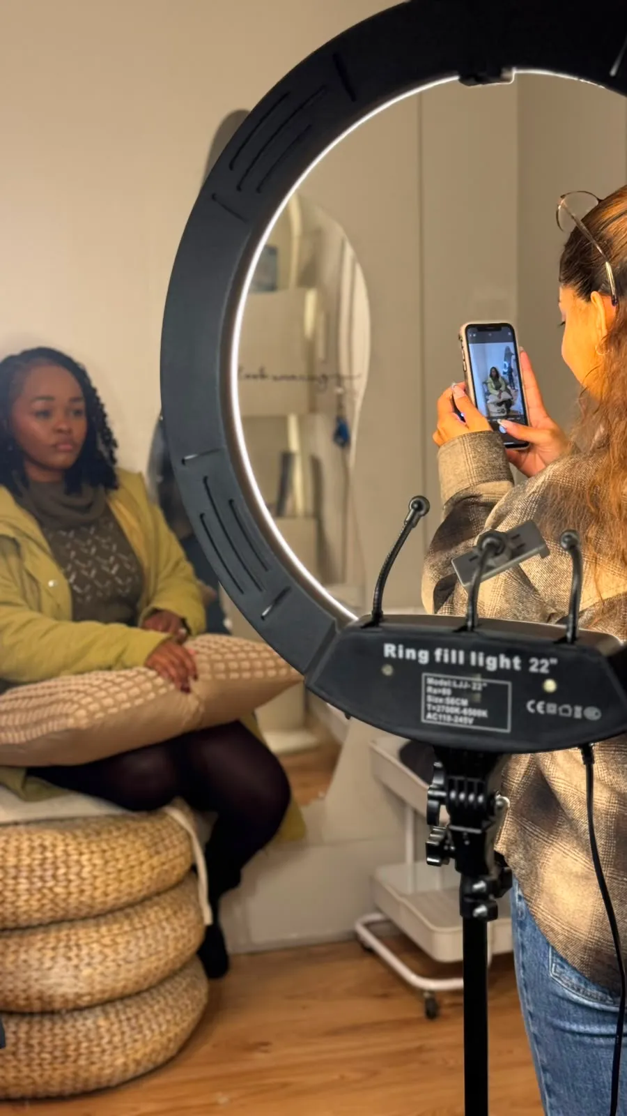 Taliyah filming a client through a ring light
